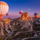 Le mongolfiere sorvolano la Cappadocia al tramonto, offrendo viste spettacolari su paesaggi lunari, camini delle fate e colori magici del cielo.