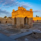 Il Tempio del Fuoco di Absheron in Azerbaigian mostra antiche strutture in pietra e bracieri alimentati da gas naturale, simbolo del culto del fuoco in un’atmosfera suggestiva.