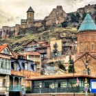 La città vecchia di Tbilisi affascina con case in legno e vicoli storici, mentre la Fortezza di Narikala domina dall’alto, custode millenaria della città.