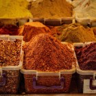 Colorato assortimento di spezie georgiane al mercato di Kutaisi, simbolo della cucina locale. Profumi intensi e sapori autentici tra bancarelle vivaci.