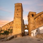 La Puerta de Santiago introduce al nucleo medievale di Trujillo attraverso un passaggio ad arco, affiancato da robuste torri in pietra appartenenti all’antica cinta muraria difensiva.