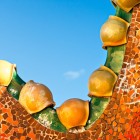 Il tetto di Casa Batlló disegna un profilo ondulato rivestito di ceramiche arancioni e verdi; le sfere smaltate ne accentuano le forme organiche ispirate al dorso del drago.
