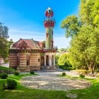 Tra i giardini di Comillas, El Capricho di Gaudí sorprende con mattoni, ceramiche a girasole e una torre orientaleggiante, fondendo architettura, musica e natura.