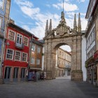 Nel cuore di Braga, l’elegante Arco da Porta Nova, ridisegnato nel 1772 da André Soares, incornicia una strada storica tra facciate colorate, azulejos e balconi in ferro battuto